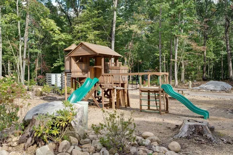 a building outdoor space with patio furniture and garden