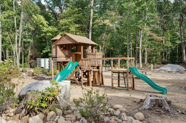 a building outdoor space with patio furniture and garden