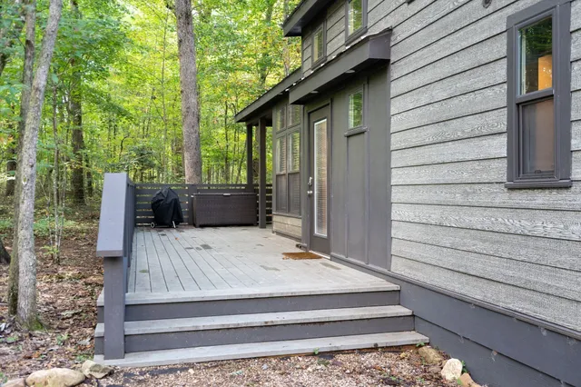 a view of backyard with wooden deck and furniture