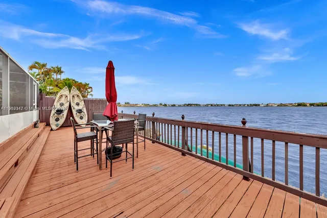 a view of a balcony with furniture and wooden floor