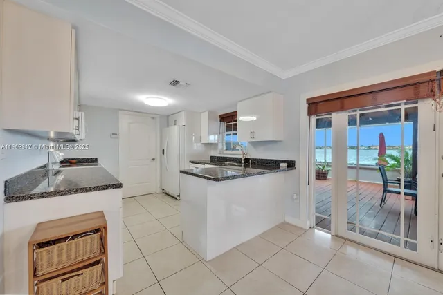 a kitchen with granite countertop a sink and a stove top oven