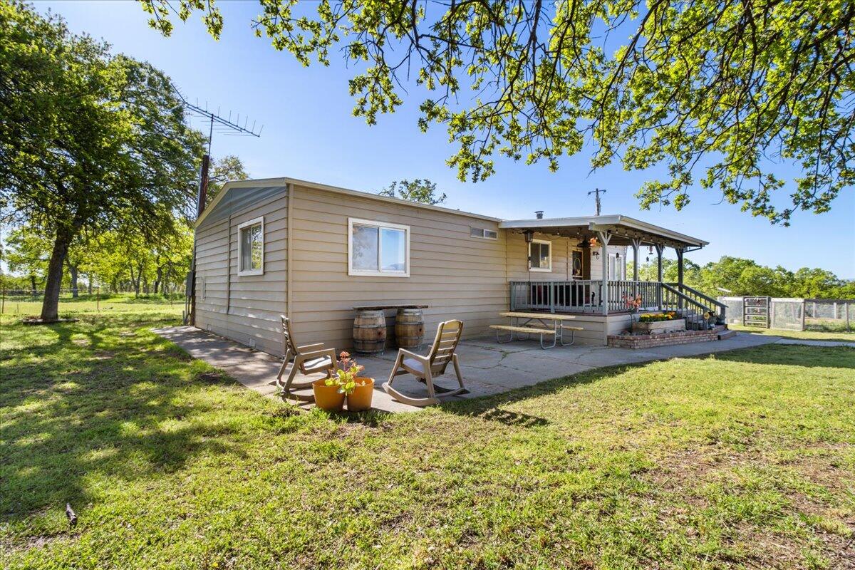 16455 Ridge Road Red Bluff, CA 96080 - Photo 22 of 56 a backyard of a house with table and chairs