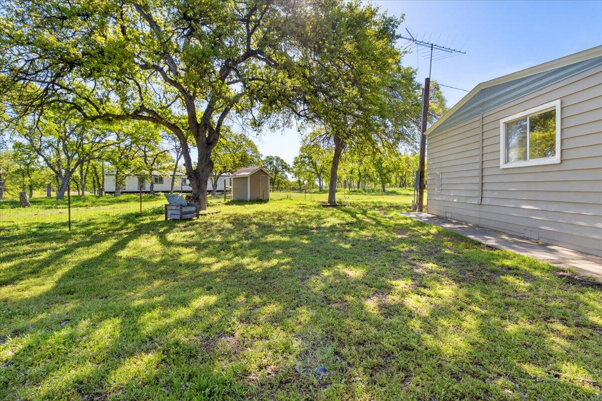 16455 Ridge Road Red Bluff, CA 96080 - Photo 26 of 56 a backyard of a house with a large tree