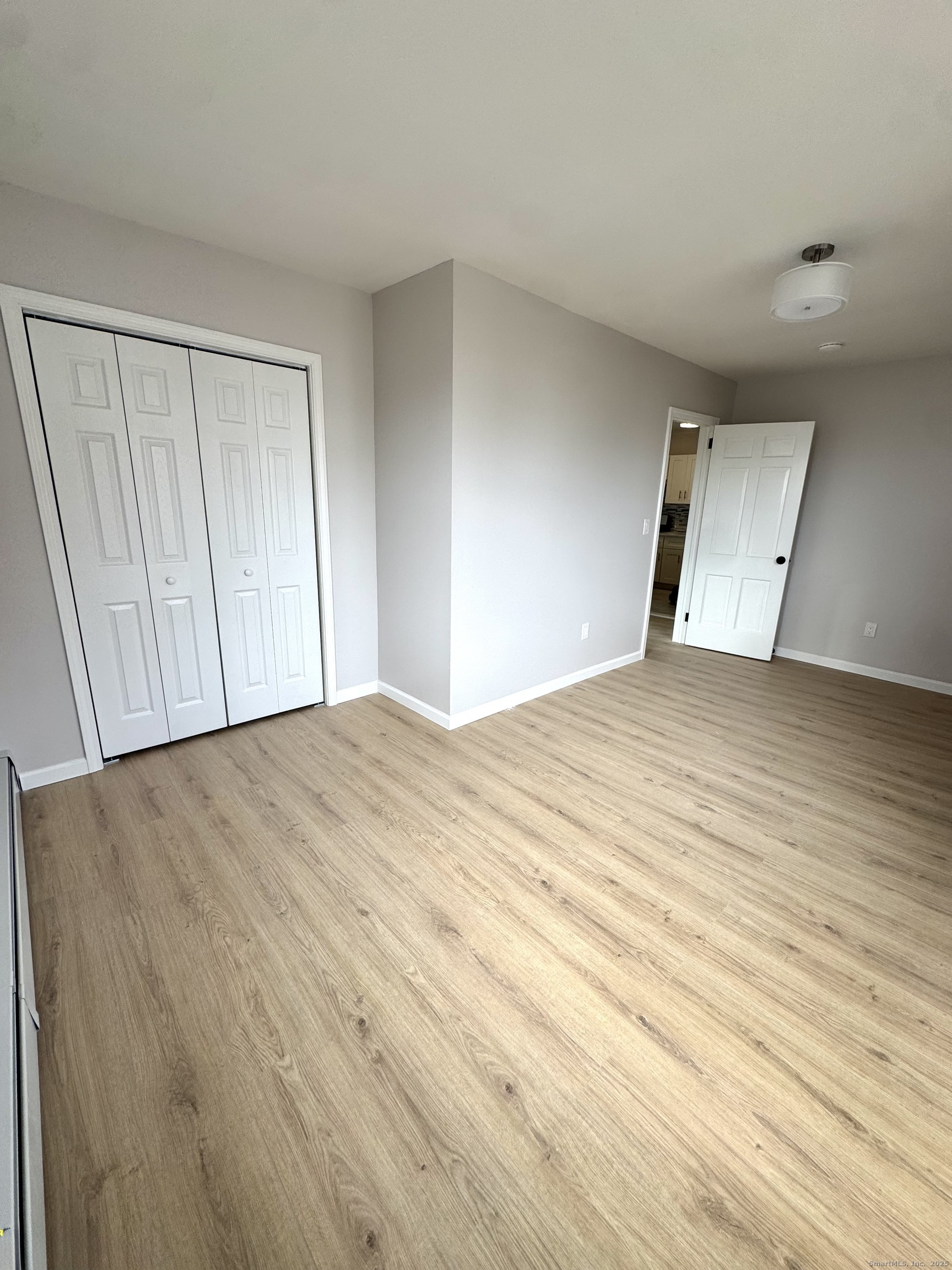 24 Woodbury Avenue, Unit 1A Norwalk, CT 06850 - Photo 5 of 7 a view of empty room with wooden floor