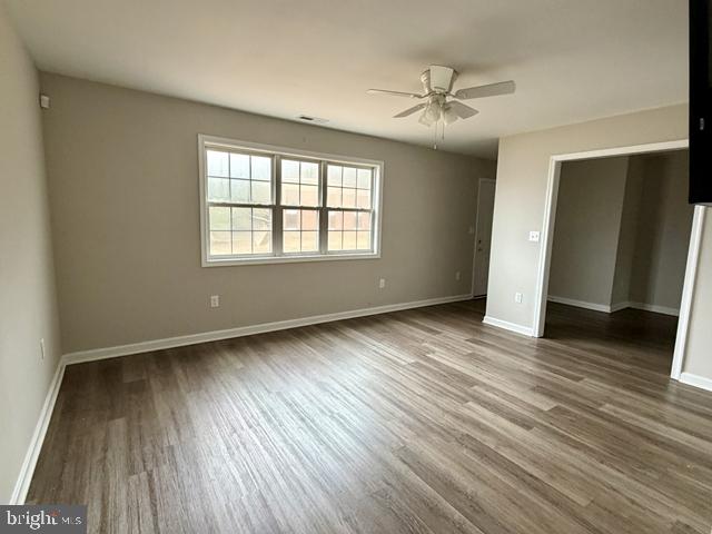 2120 Ruxton Drive Salisbury, MD 21801 - Photo 11 of 18 an empty room with wooden floor and windows