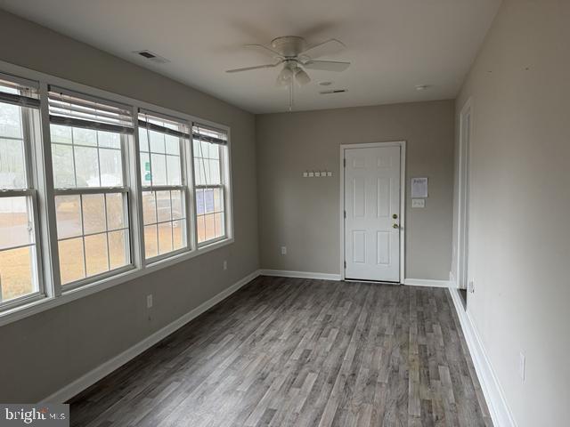 2120 Ruxton Drive Salisbury, MD 21801 - Photo 6 of 18 a view of an empty room with a window and wooden floor