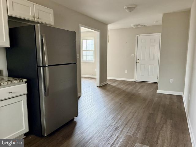 2120 Ruxton Drive Salisbury, MD 21801 - Photo 9 of 18 a view of a kitchen with wooden floor and a refrigerator