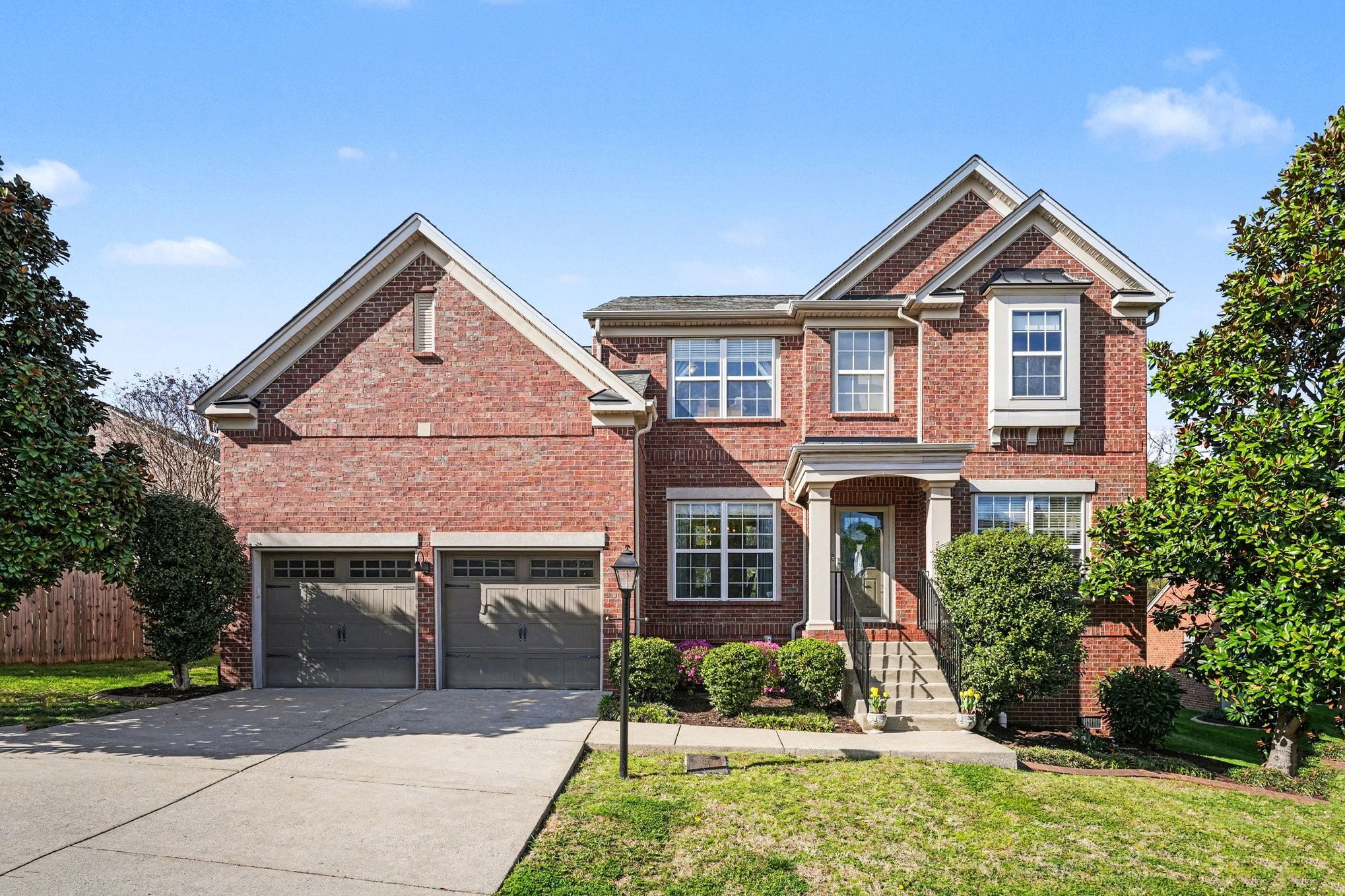344 Landings Way Mount Juliet, TN 37122 - Photo 2 of 26 a front view of a house with a yard and potted plants