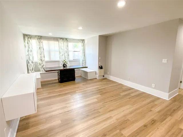 a large room with wooden floor and furniture
