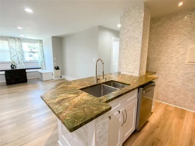 a kitchen with sink stove and cabinets