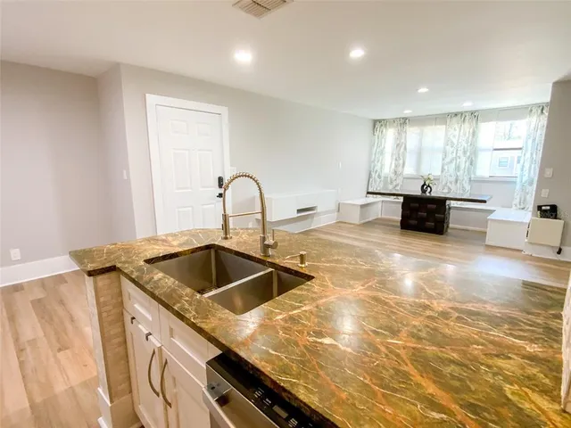 a kitchen with a sink and cabinets