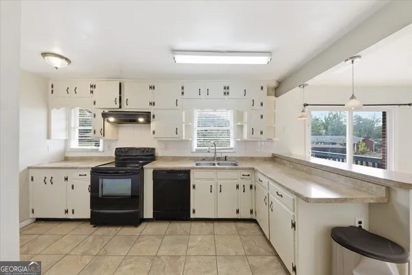 a kitchen with a sink stove and cabinets