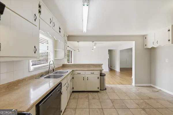 a kitchen with a stove a sink and a refrigerator