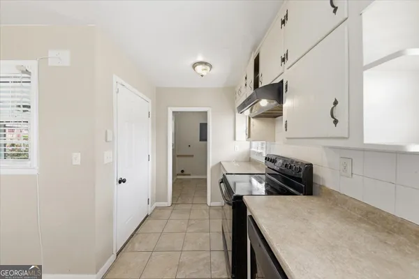 a kitchen with granite countertop a stove and a refrigerator