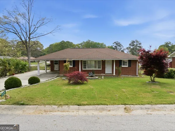 a front view of a house with a yard
