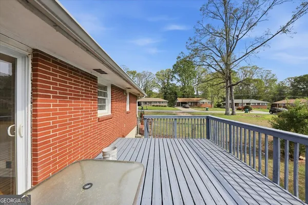 a view of a balcony with wooden floor and fence