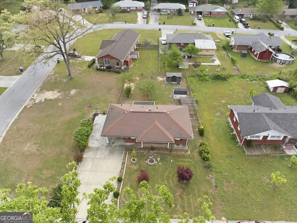 an aerial view of residential houses with outdoor space