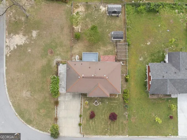 an aerial view of a house with a yard