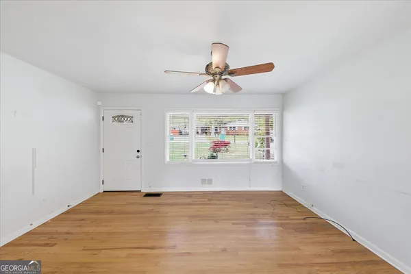 a view of room with window and ceiling fan