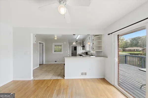 a view of kitchen and hall with wooden floor