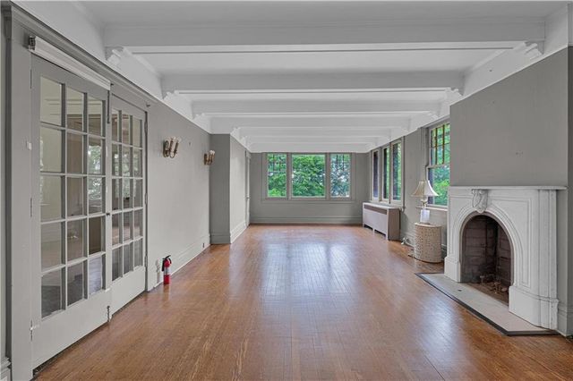 a view of livingroom with furniture a fireplace and wooden floor