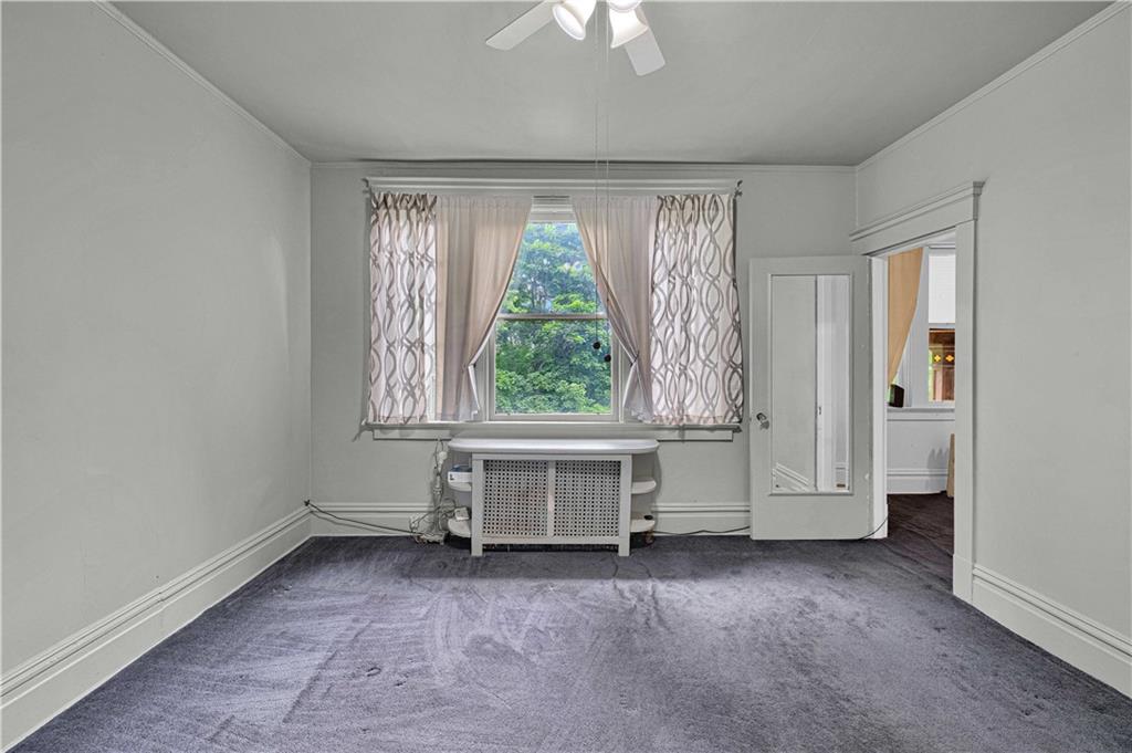 4283 Andover Terrace Pittsburgh, PA 15213 - Photo 20 of 25 an empty room with a window and a ceiling fan