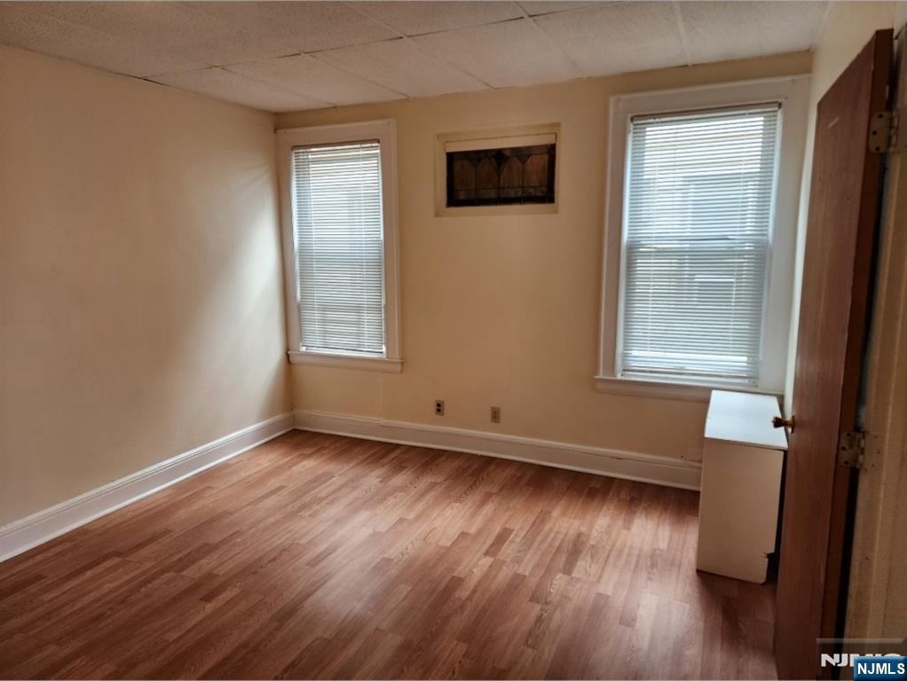 196 West End Newark, NJ 07106 - Photo 15 of 39 a view of an empty room with wooden floor and a window