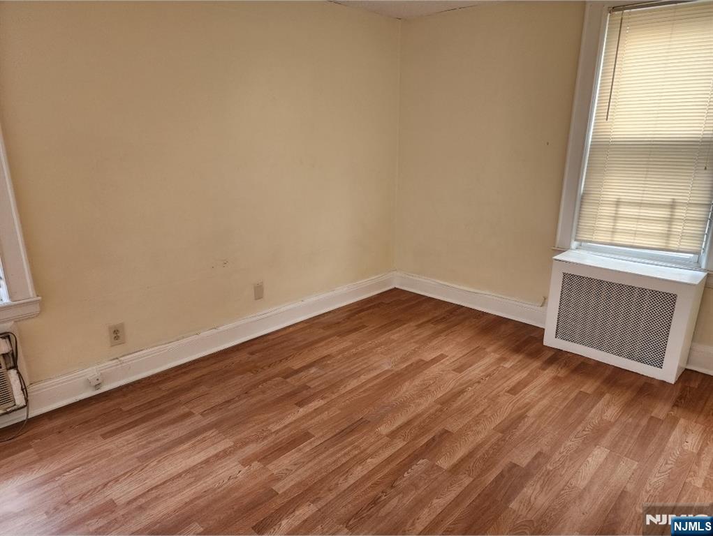 196 West End Newark, NJ 07106 - Photo 17 of 39 an empty room with wooden floor and windows