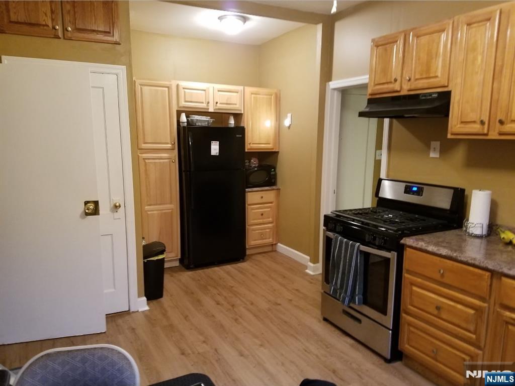 196 West End Newark, NJ 07106 - Photo 32 of 39 a kitchen with stainless steel appliances granite countertop a refrigerator and a stove