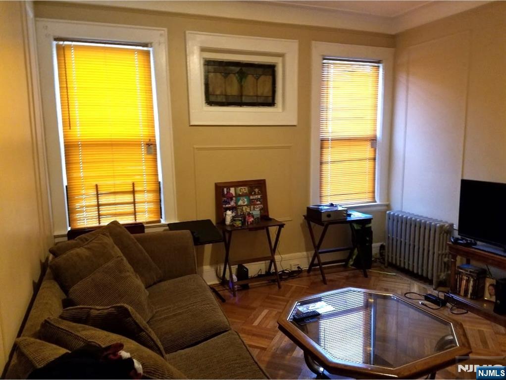 196 West End Newark, NJ 07106 - Photo 33 of 39 a living room with furniture and a flat screen tv