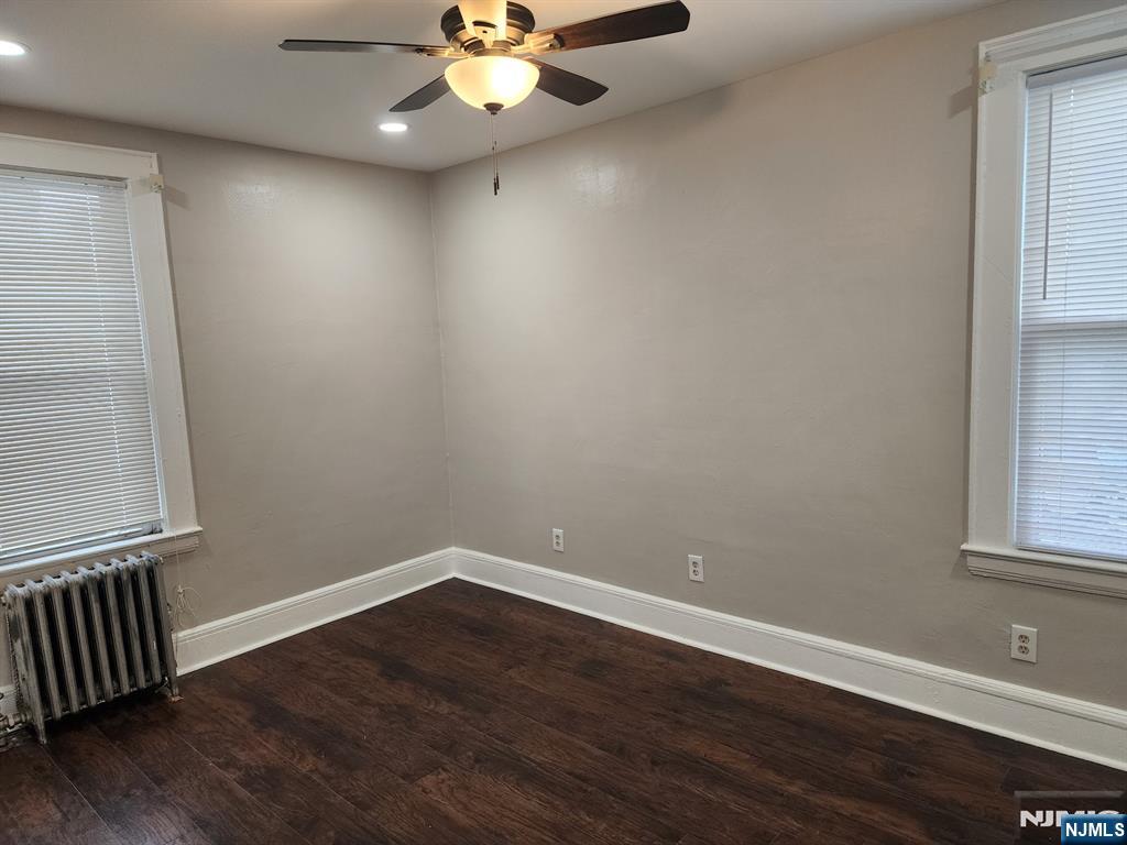 196 West End Newark, NJ 07106 - Photo 8 of 39 a view of an empty room with wooden floor and a window