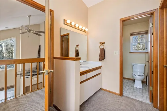 a bathroom with a walk in closet and wooden floor