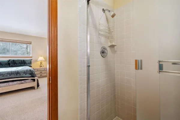 a bedroom with a bed and a large window