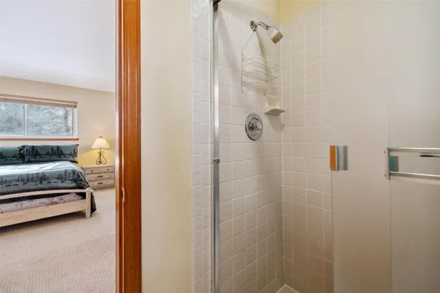 a bedroom with a bed and a large window