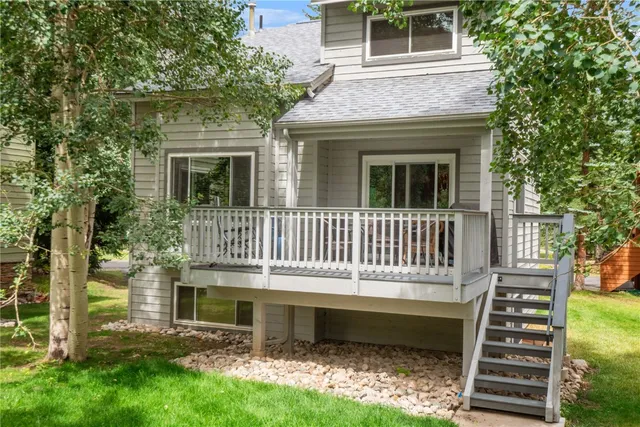 a view of a house with a yard and sitting area