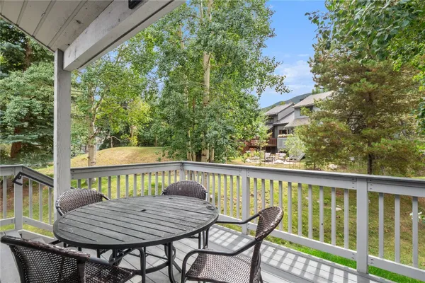 a view of balcony with a table and chairs