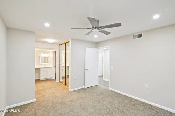 a view of an empty room with a ceiling fan