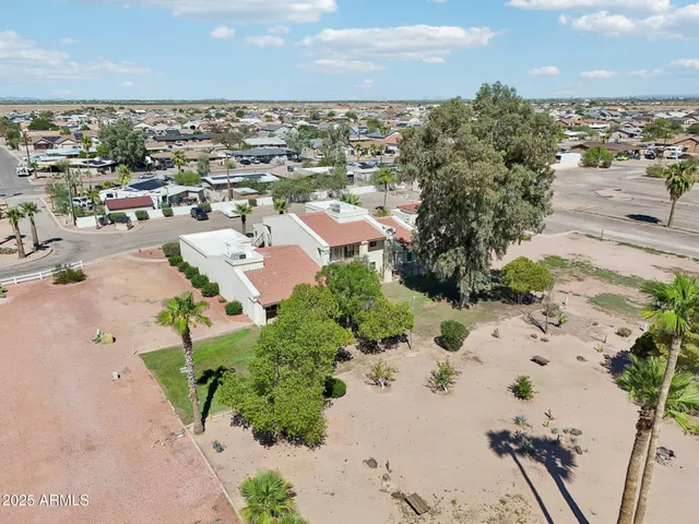 an aerial view of multiple houses with yard