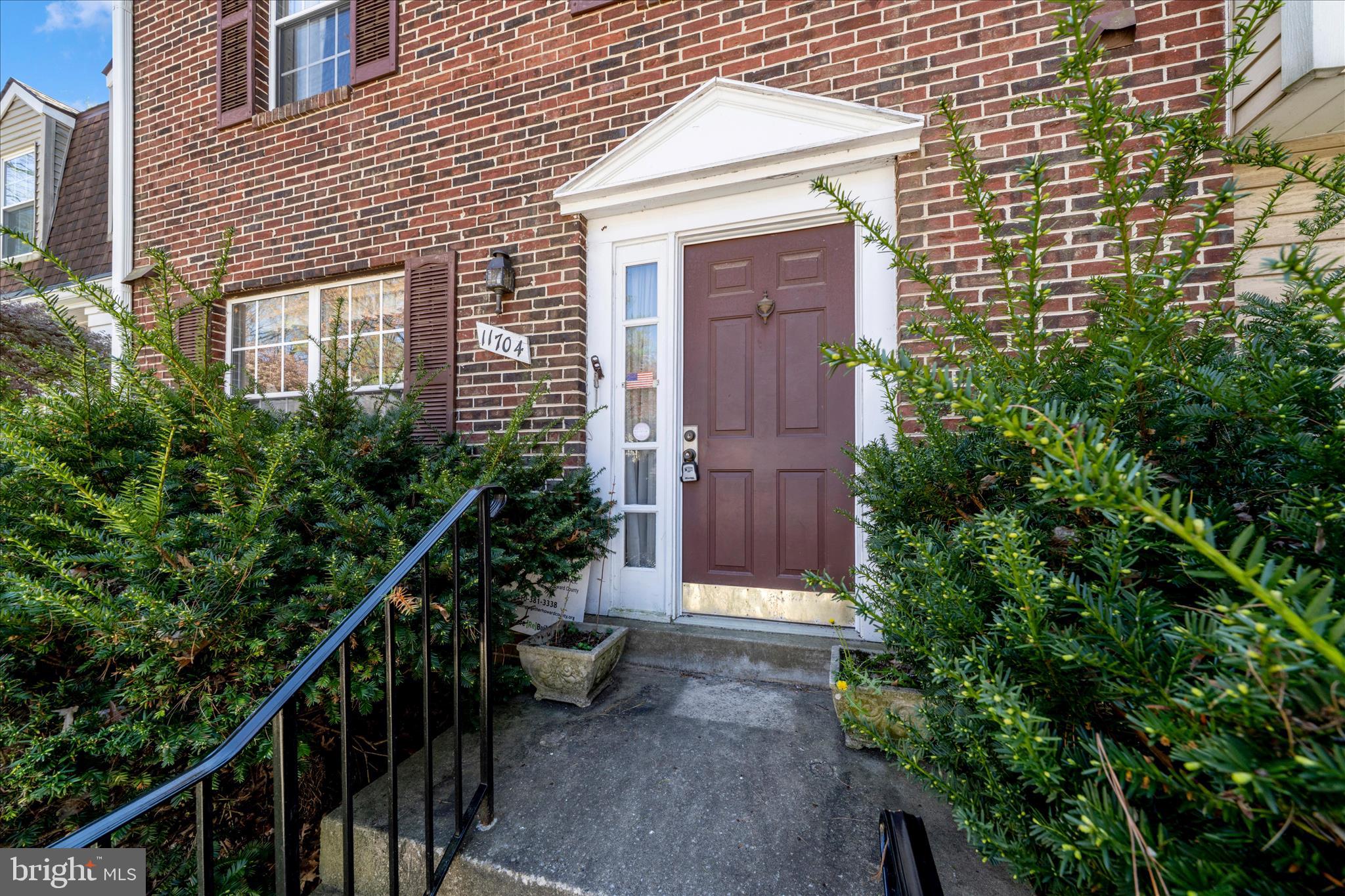 11704 Lone Tree Court Columbia, MD 21044 - Photo 22 of 38 a view of a house with wooden fence and potted plants