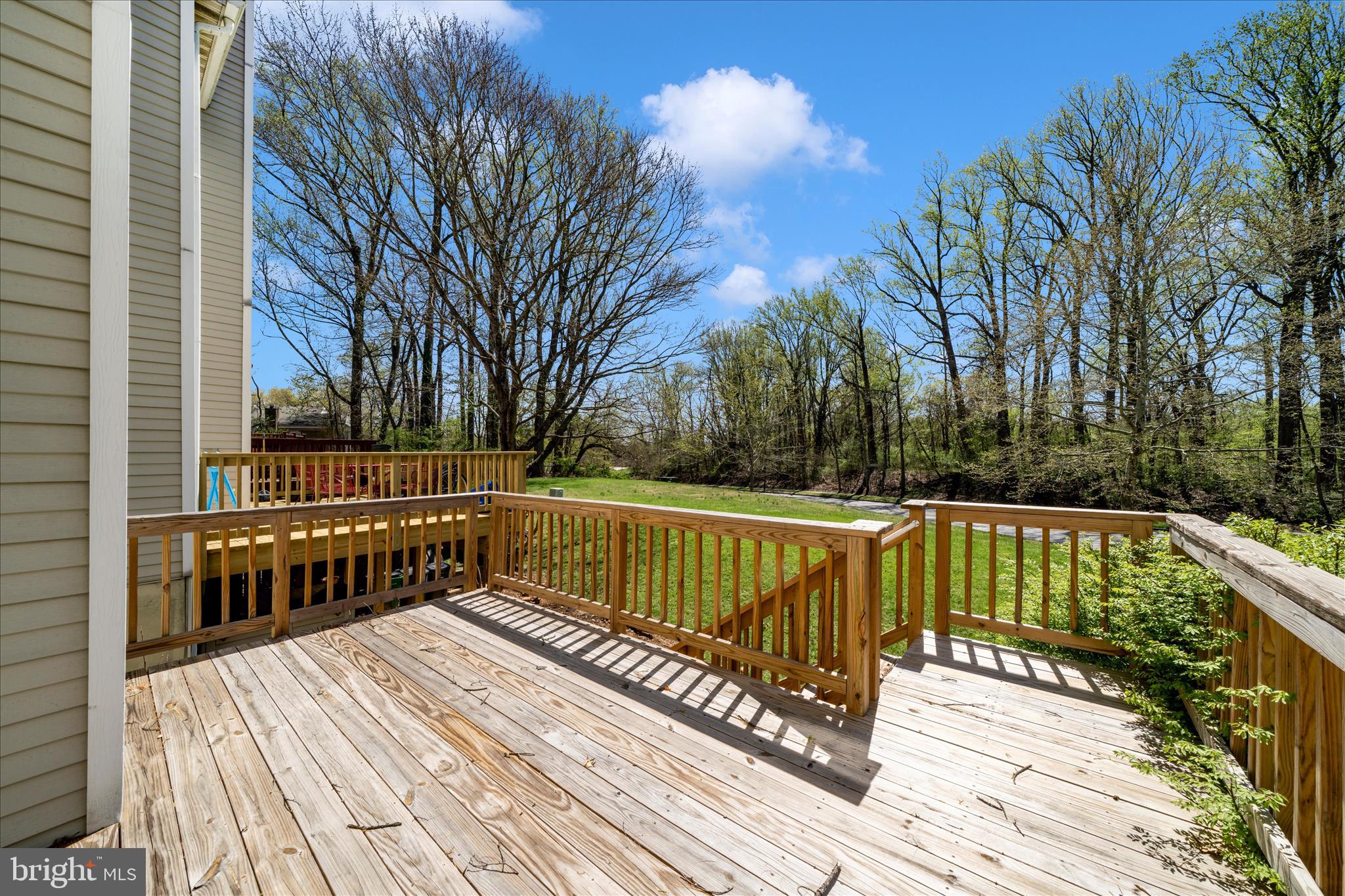 11704 Lone Tree Court Columbia, MD 21044 - Photo 32 of 38 a view of balcony with wooden floor and outdoor seating
