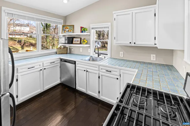 a hallway with painting on the wall and a granite counter tops
