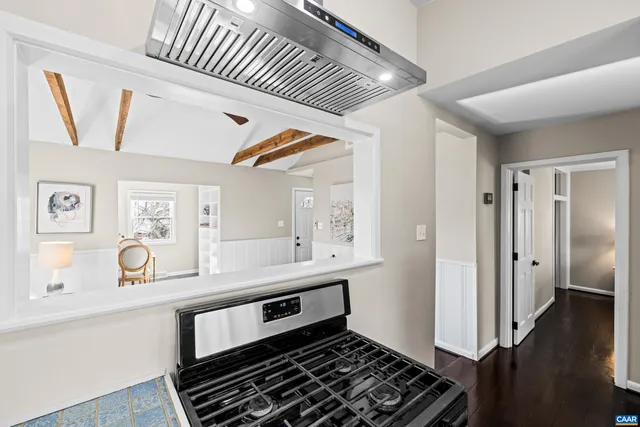 a kitchen with wooden cabinets a sink a stove and a window