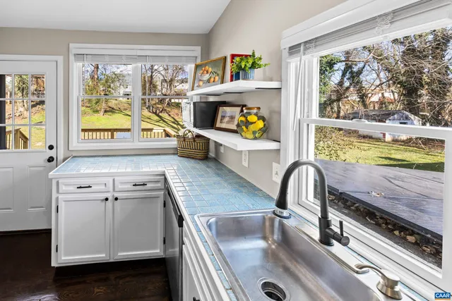 a view of sitting area on roof deck with wooden floor and fence
