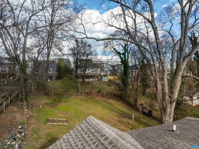 a view of a street with cars parked