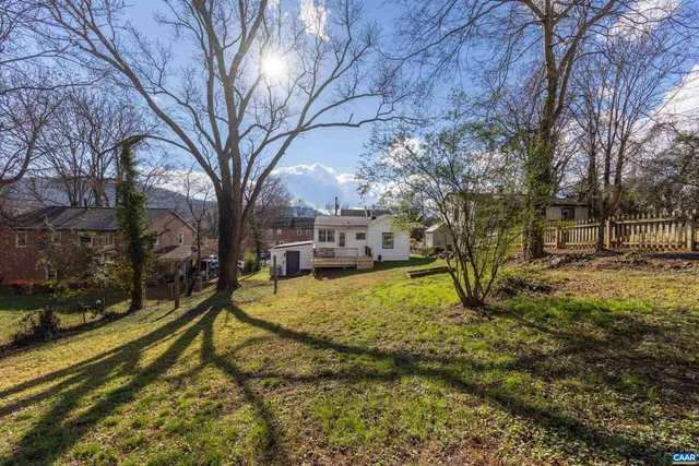 a view of a house with wooden deck and furniture