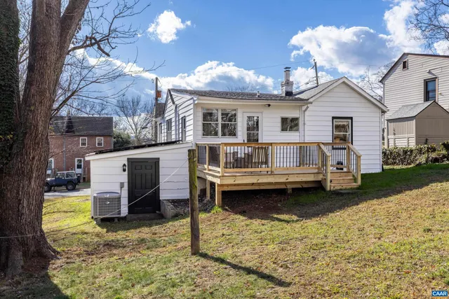 a view of a white house with a yard