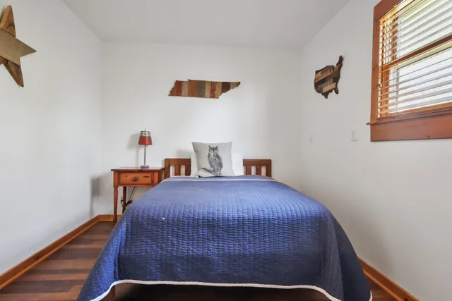 a bedroom with a bed and window