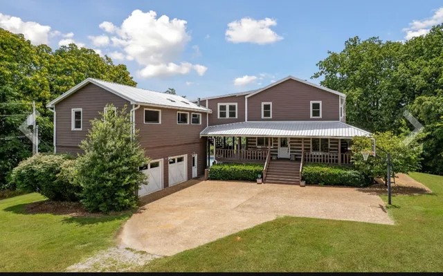 a front view of a house with a garden and plants