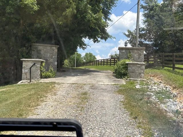 a view of a yard with iron fence