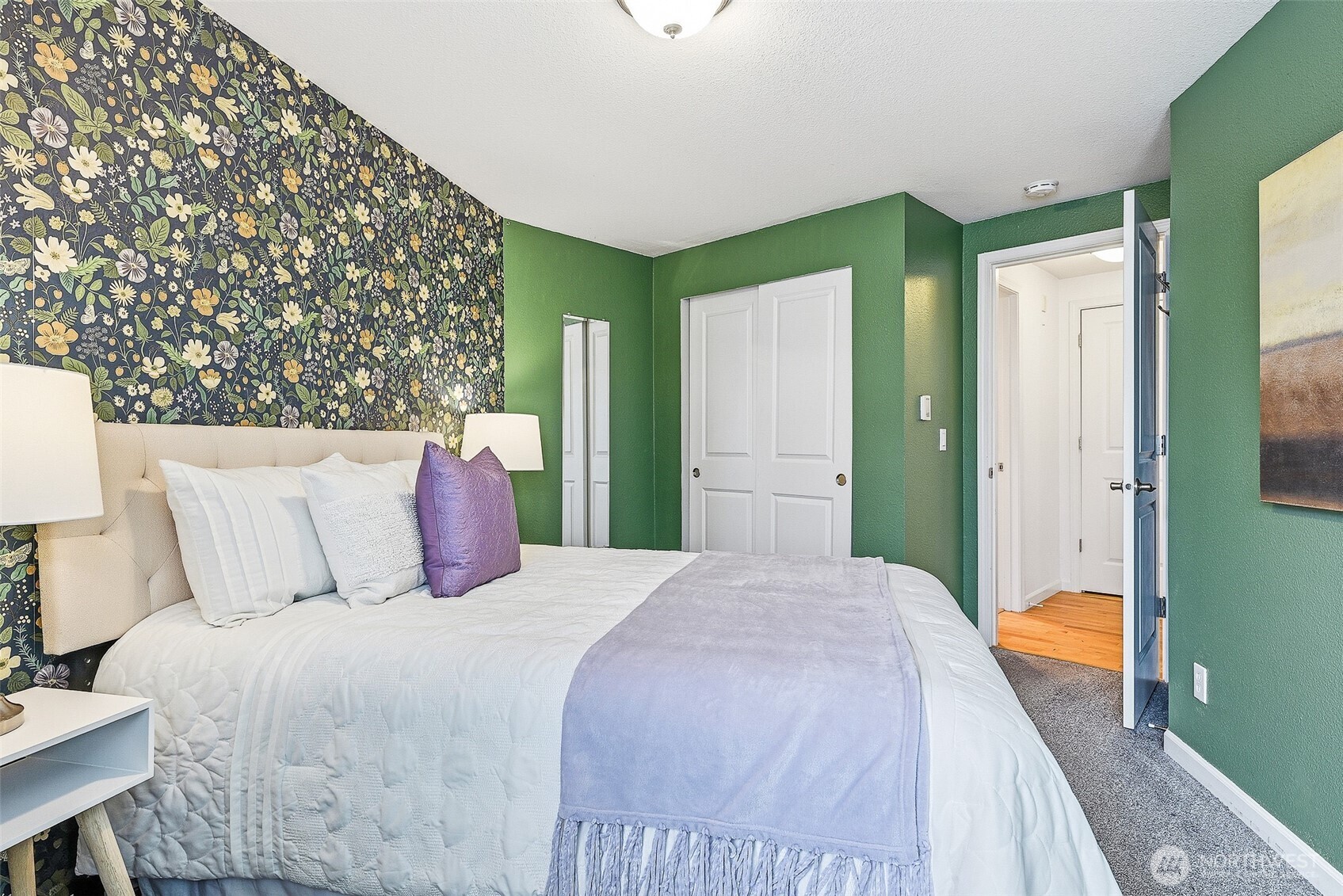 3045 20th Avenue West, Unit 409 Seattle, WA 98199 - Photo 13 of 25 a bedroom with a large bed and a chandelier
